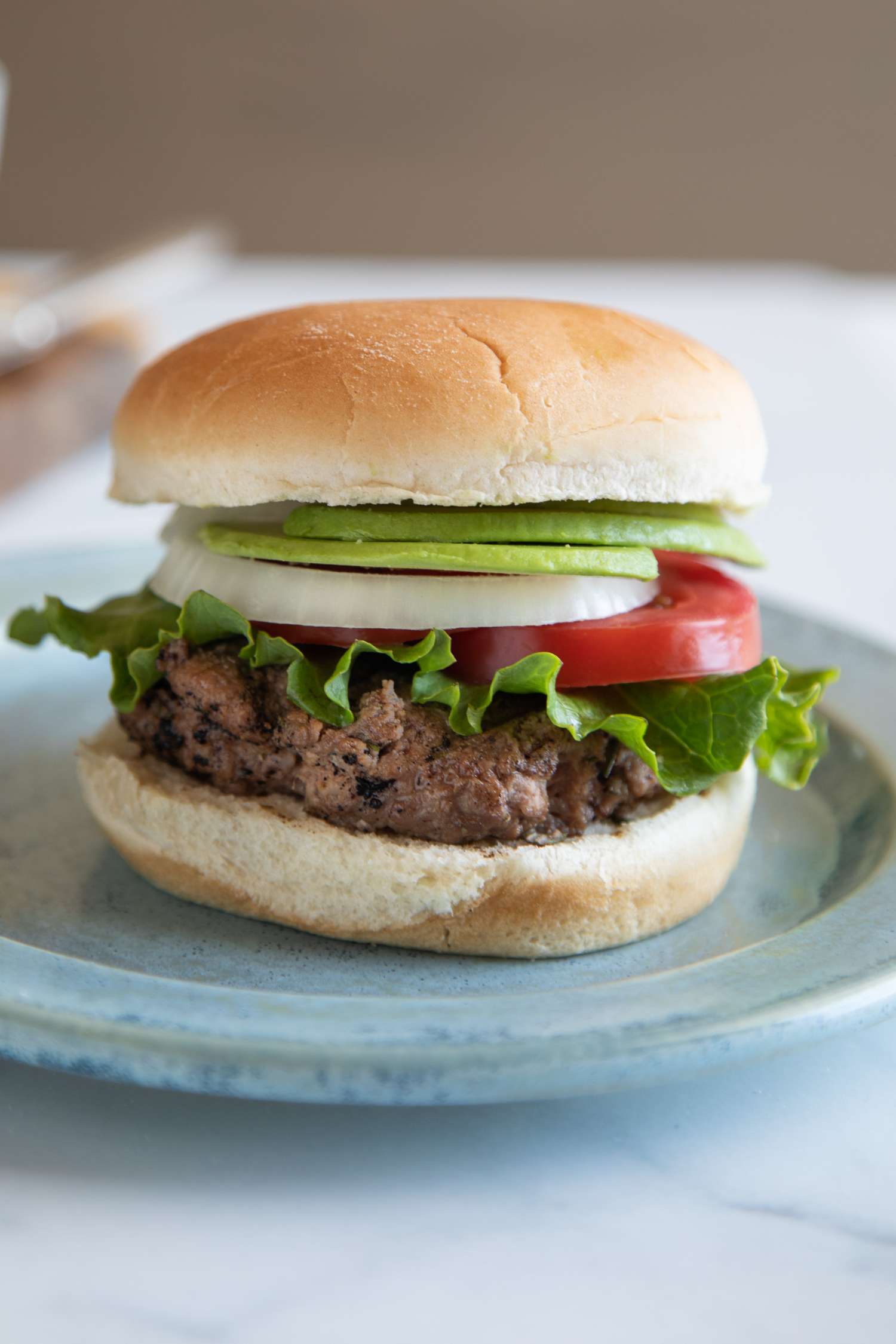 Side view of a hamburger with toppings.