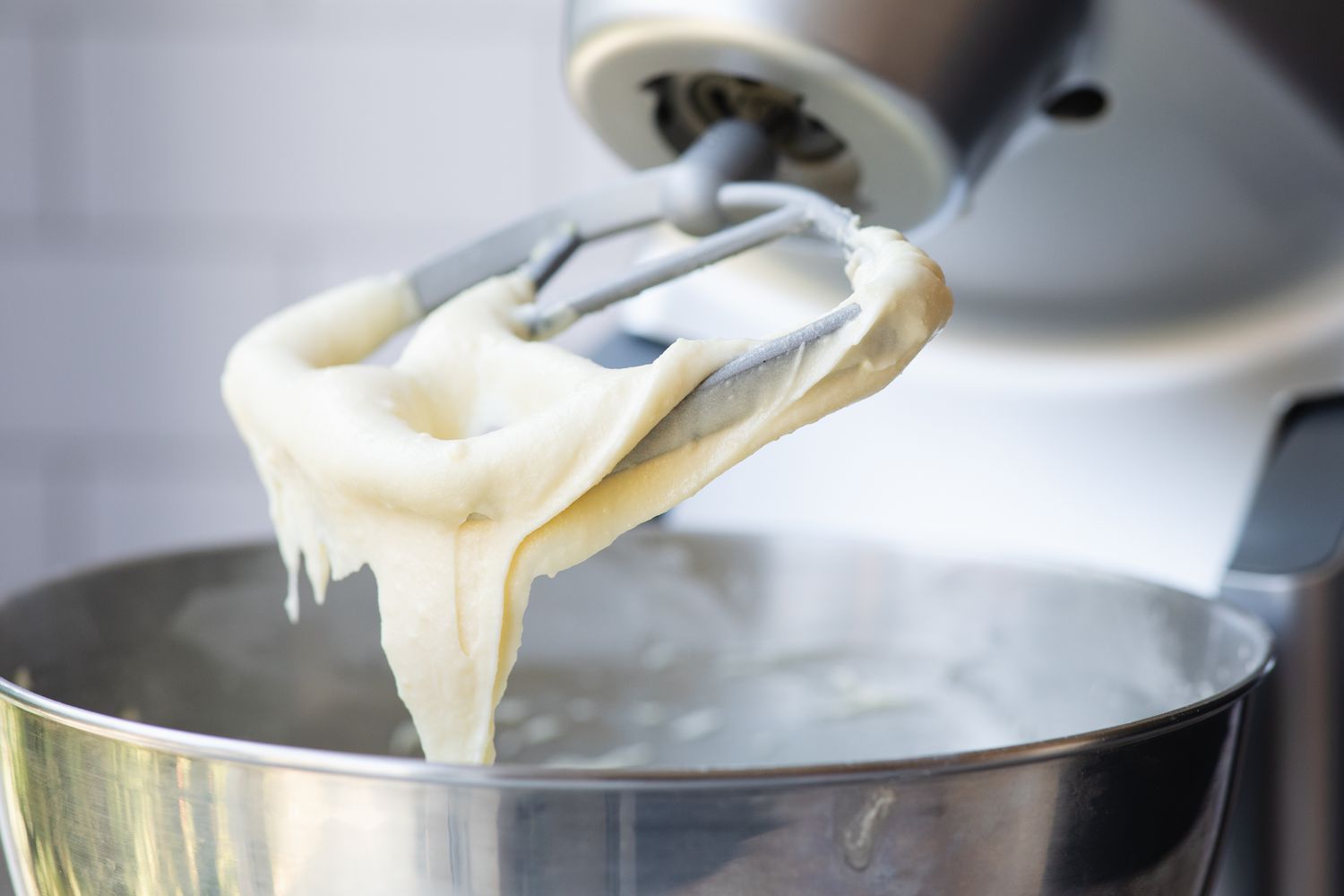 Frosting in mixing bowl to make a red velvet cupcake recipe.