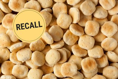 A close-up of crackers with a recall graphic stamped on top