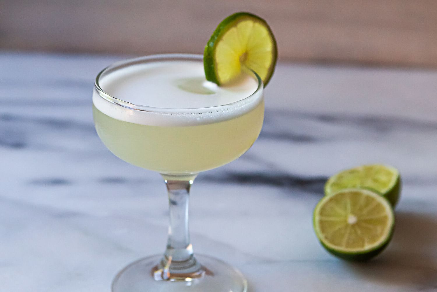 Gimlet Cocktail in a coupe glass with lime