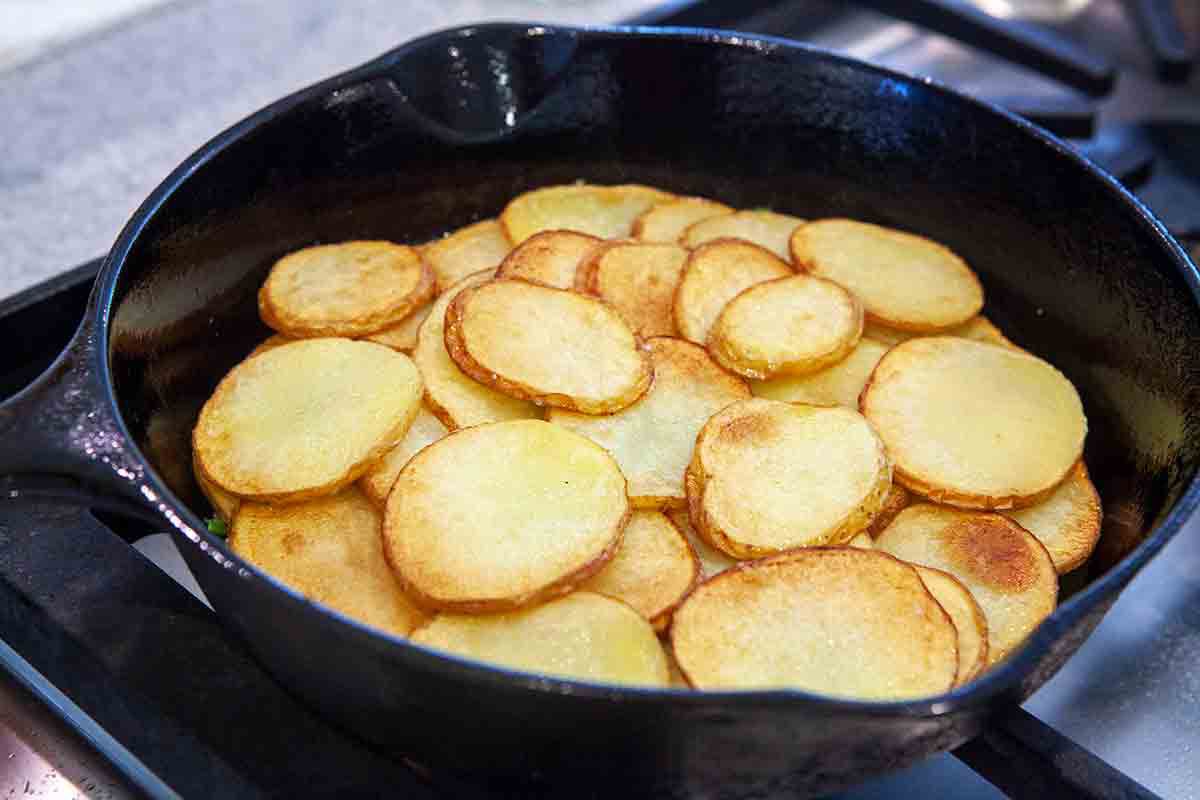 layer sliced fried potatoes on top for spanish tortilla
