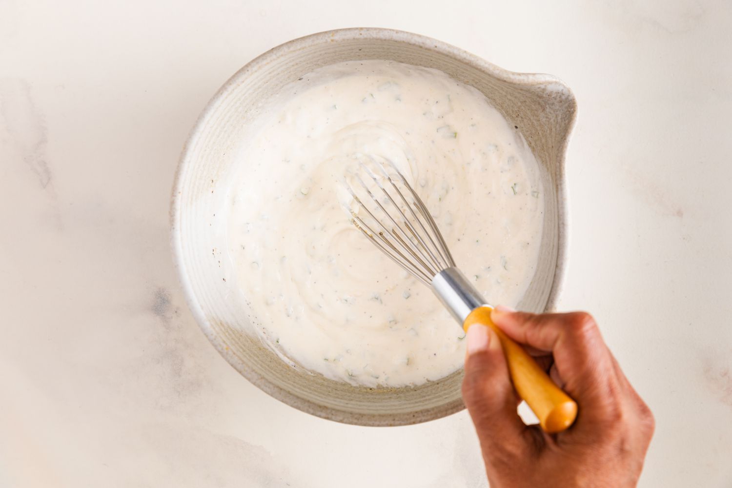 Sour Cream & Onion Dressing Ingredients Mixed Together Using a Whisk in a Bowl for Potato Salad Recipe