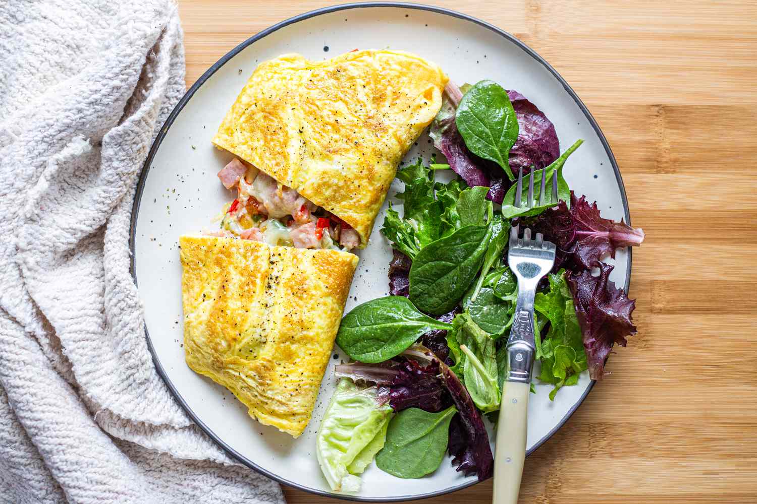 Denver Omelet with Mixed Greens on Plate and Fork