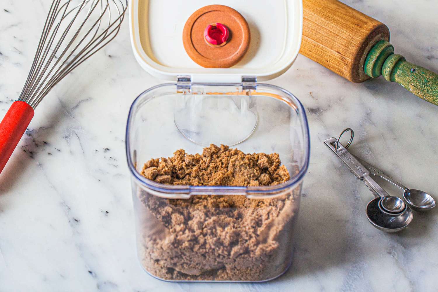 How to solve hard brown sugar by using a brown sugar keeper. The lid is open and it is filled with brown sugar.