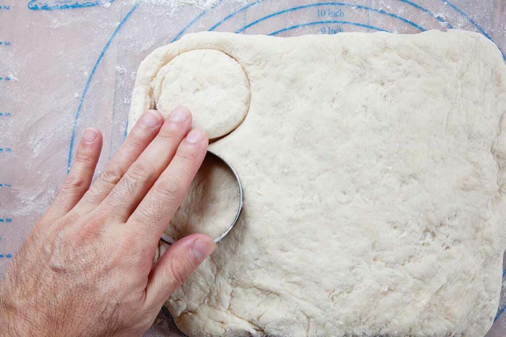 Dip 2 inch biscuit cutter into flour then cut out rounds of angel biscuit dough