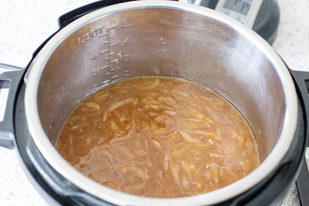 Easy Instant Pot French Onion Soup inside the metal bowl of an Instant Pot.