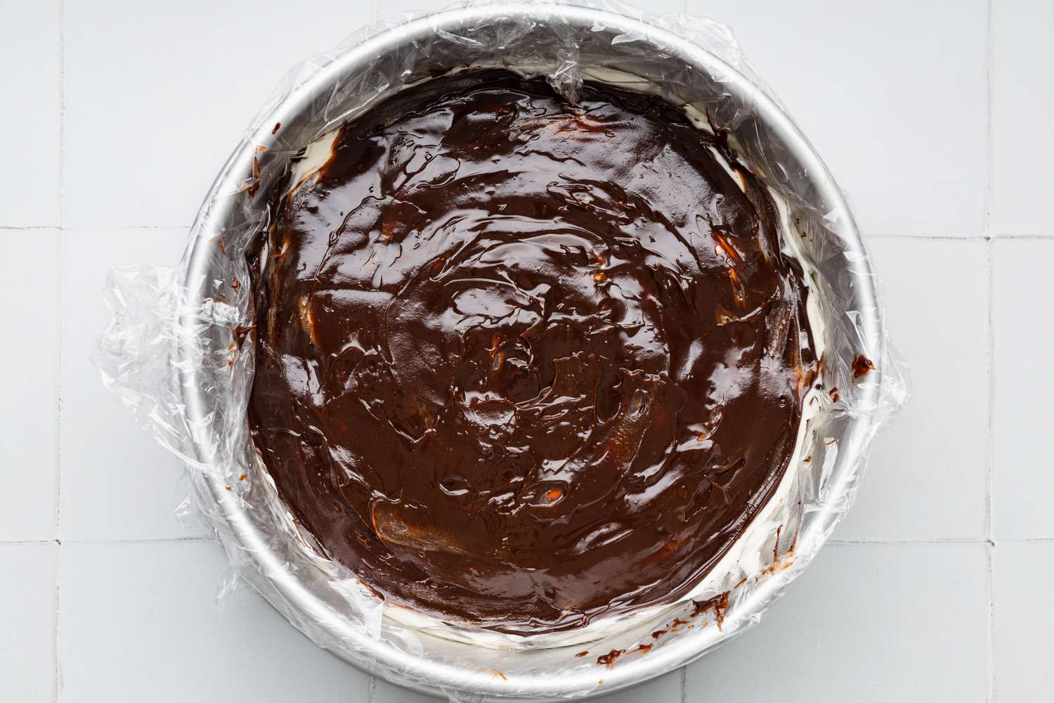 Assembling the Oreo Ice Cream Cake (Rest of the Layers): Hot Fudge Layer Added to Cake Pan With the First Layer of Ice Cream Cake