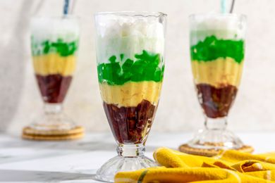 Three Glasses of ChÃ¨ Ba MÃ u Next to a Yellow Kitchen Towel