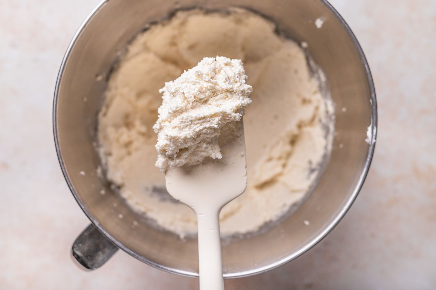 Spatula of Creamed Butter and Sugar with the Rest in the Bowl for Unicorn Cake Recipe