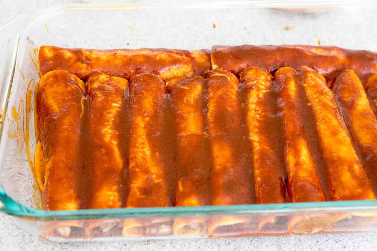 cover shredded chicken enchiladas with remaining enchiladas sauce