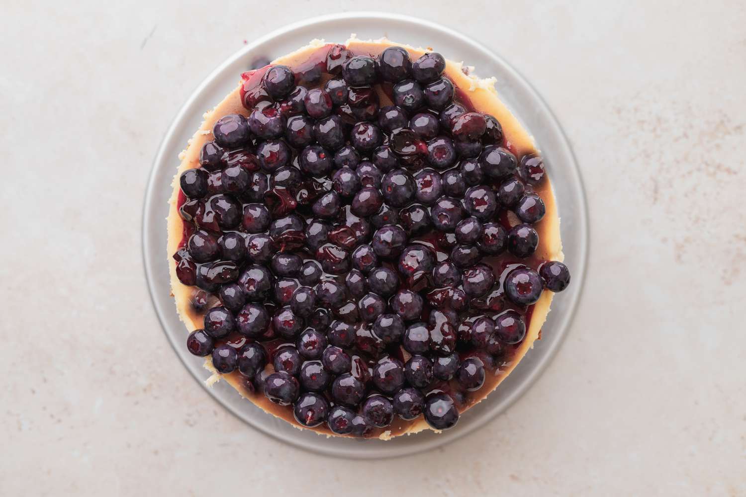 Top cheesecake with blueberry sauce. 