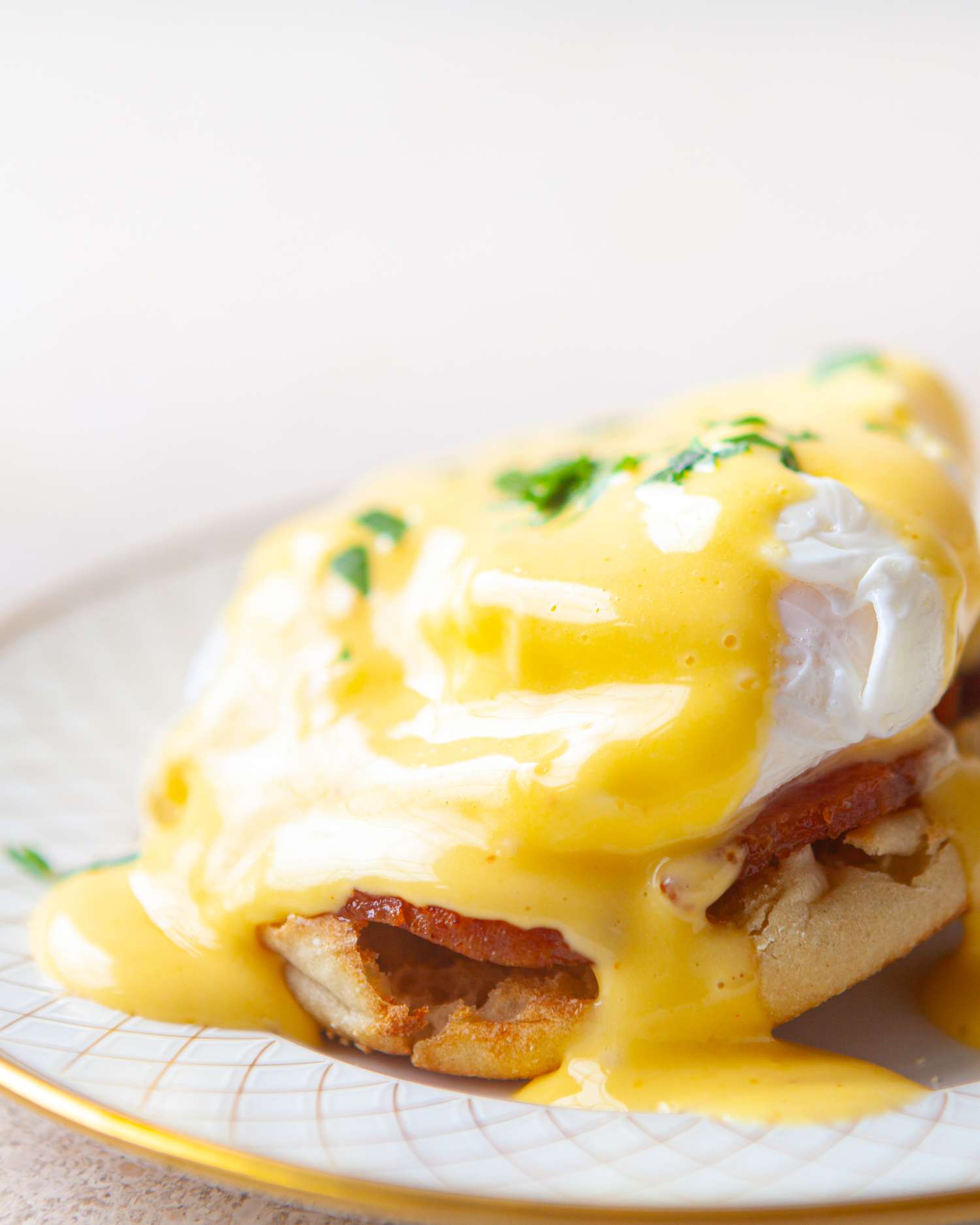 Side view of eggs benedict on a plate.