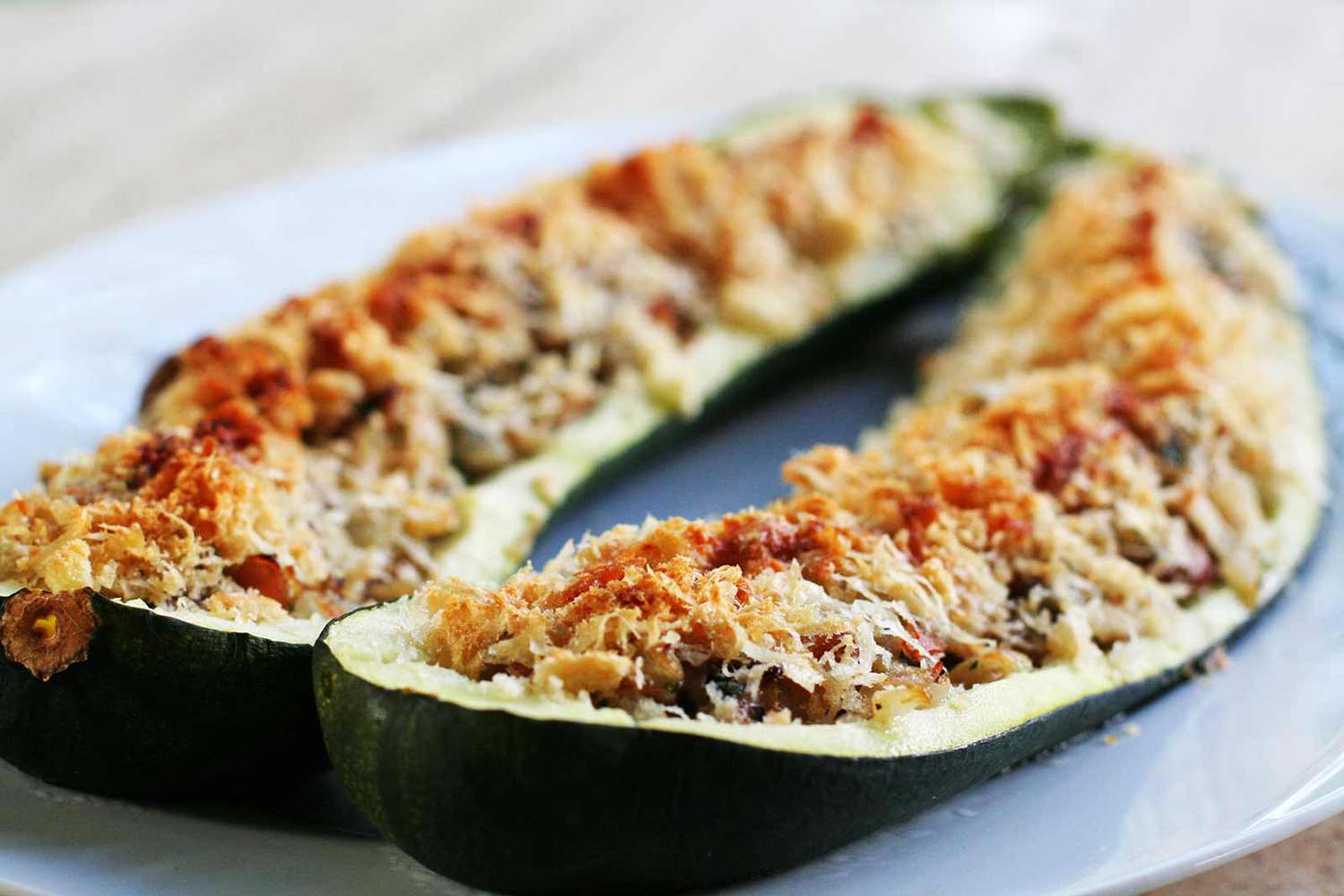 ham and mushroom stuffed zucchini topped with cheese