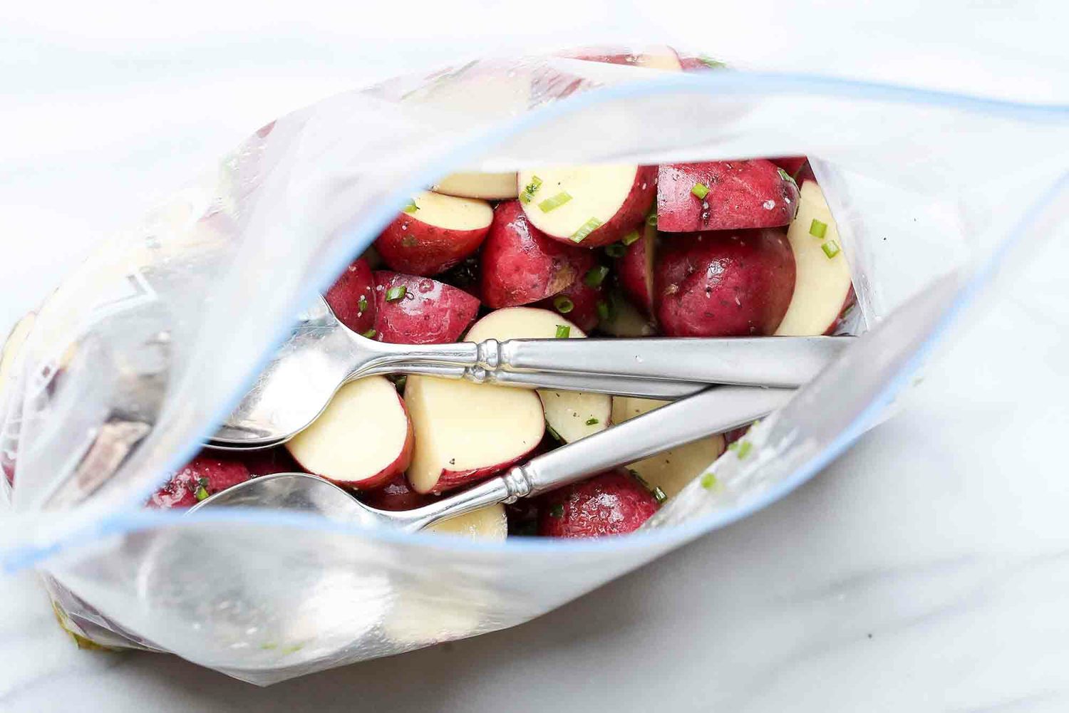 Sous Vide Potatoes add spoons to the bag