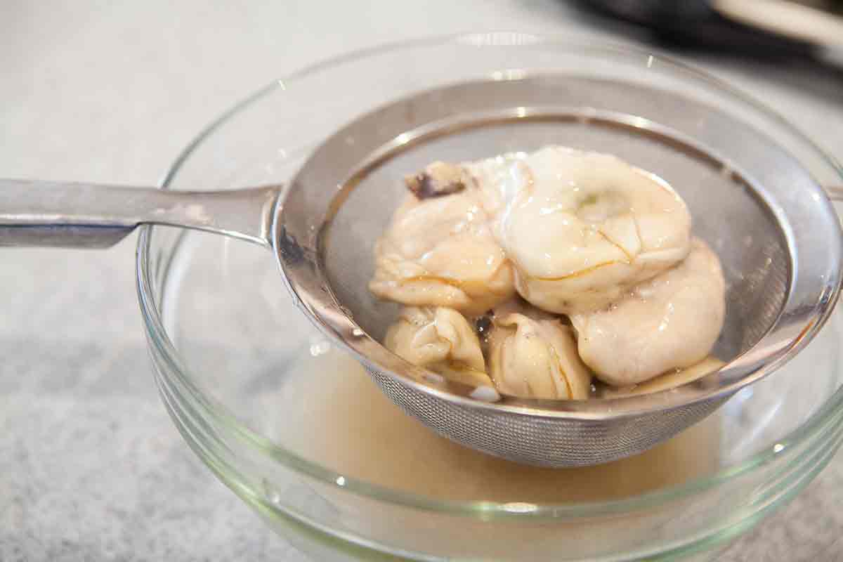 Strain canned oysters for oyster stew