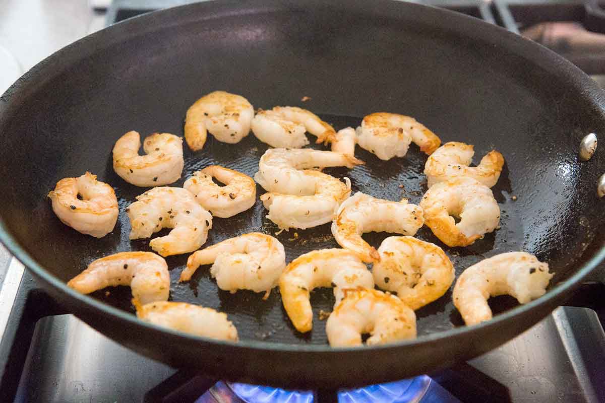 Browning shrimp cooking on a pan