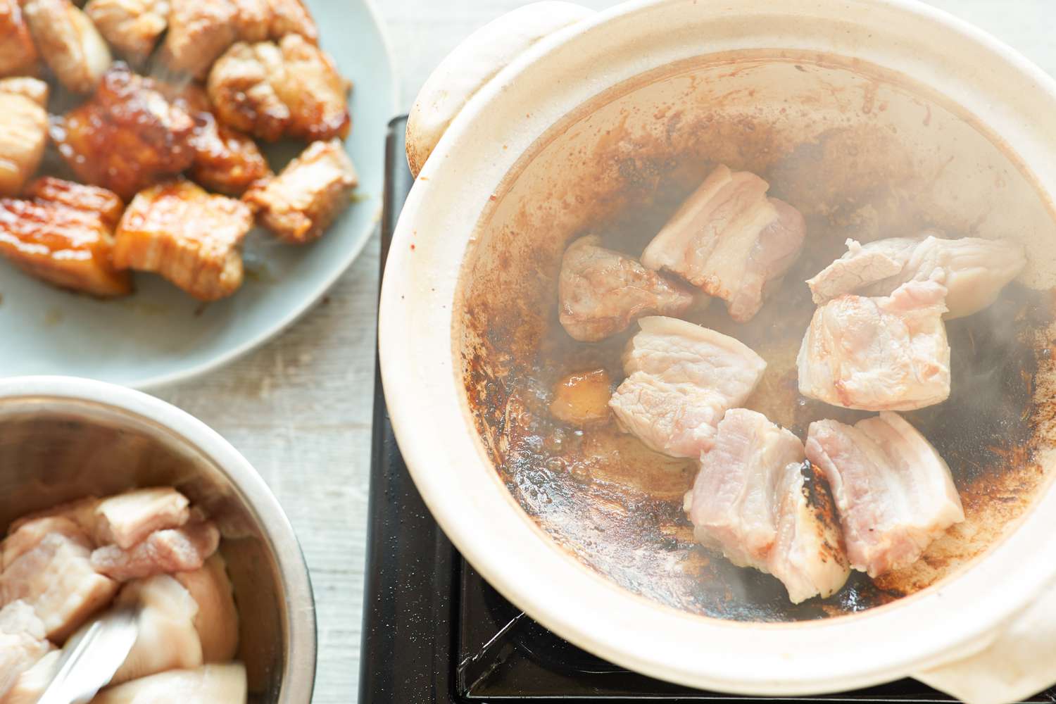 Searing pork belly in batches to make Vietnamese braised pork belly and eggs 