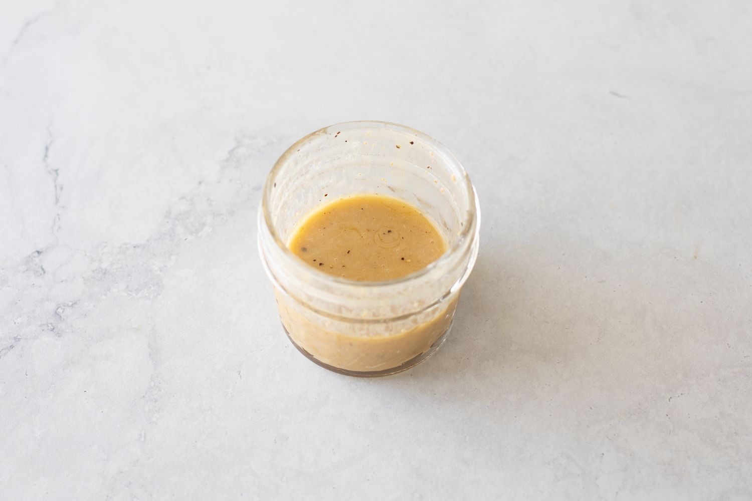 Jar of Red Wine Vinaigrette for Green Salad with Fresh Herbs 
