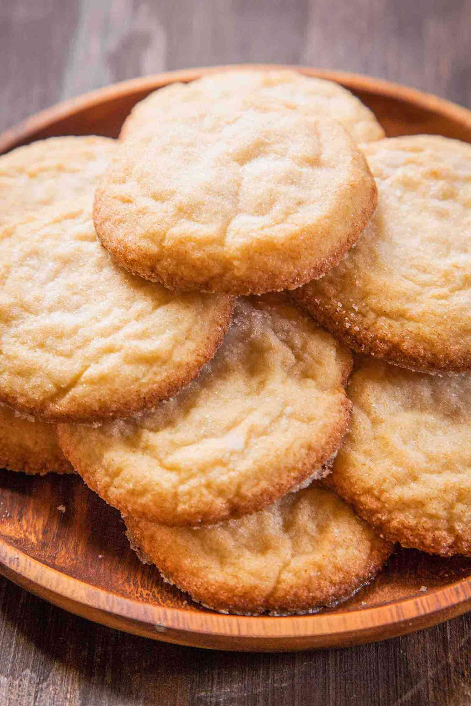 A platter of soft and chewy sugar cookies stacked up and ready to eat.