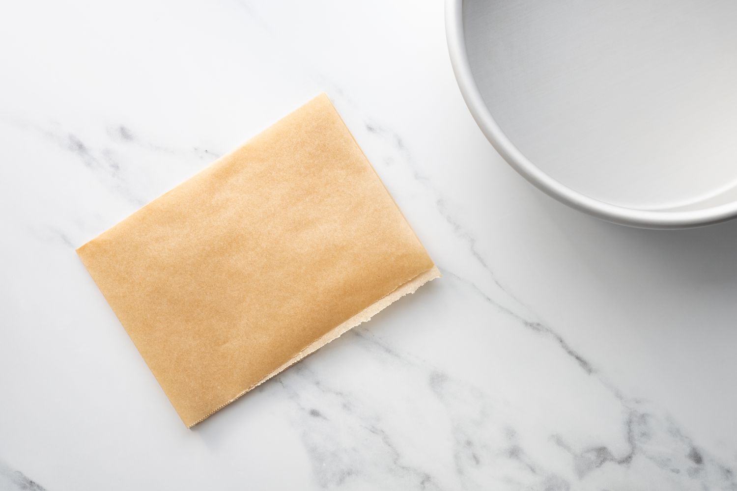 Parchment paper folded up to line a cake pan