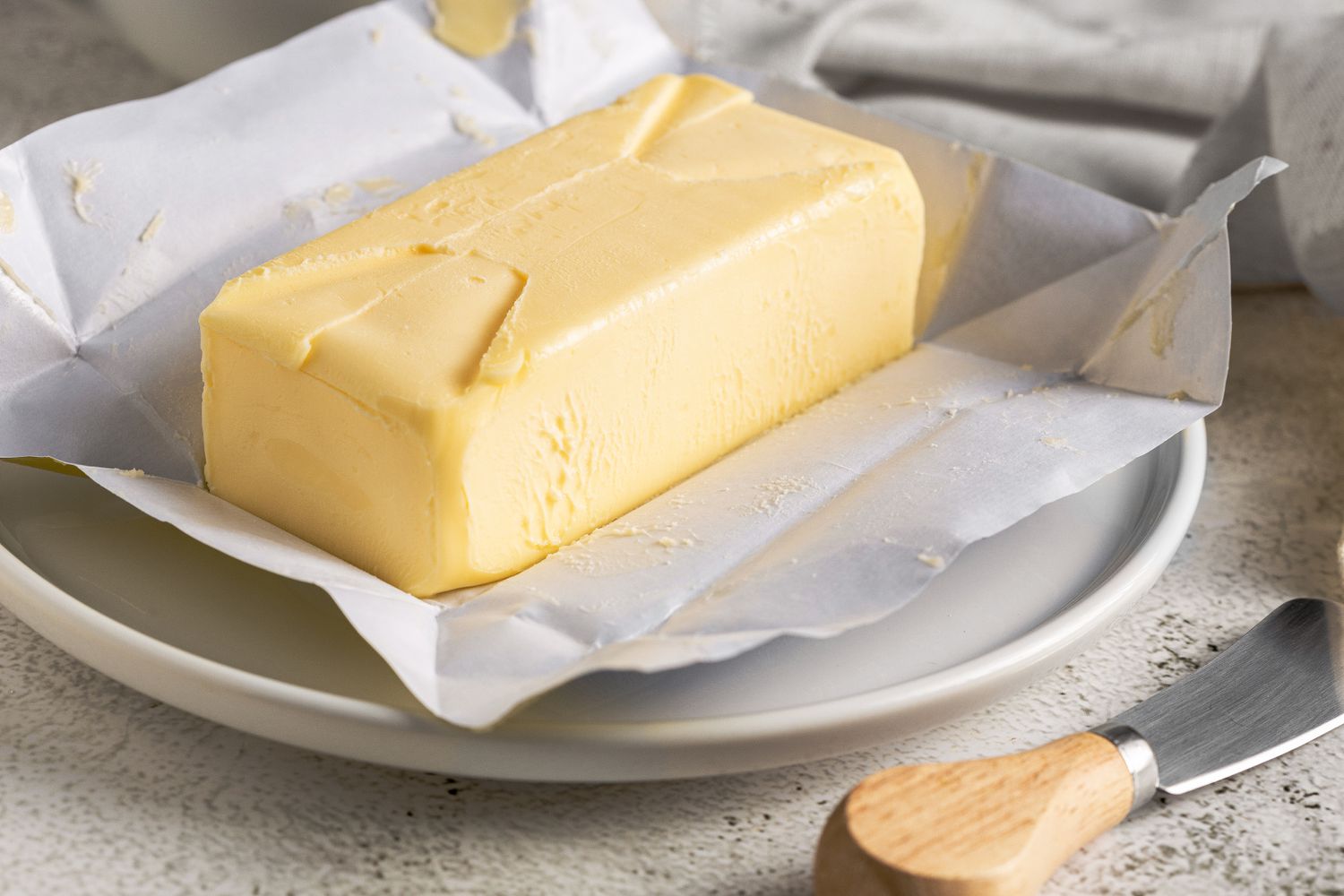 A block of butter sitting on a plate