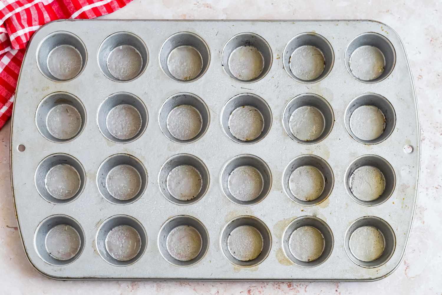 Muffin Tin Sprayed With Oil for Corn Dog Recipe