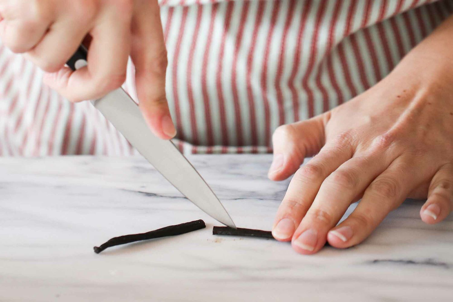Splitting a vanilla bean with a sharp knife