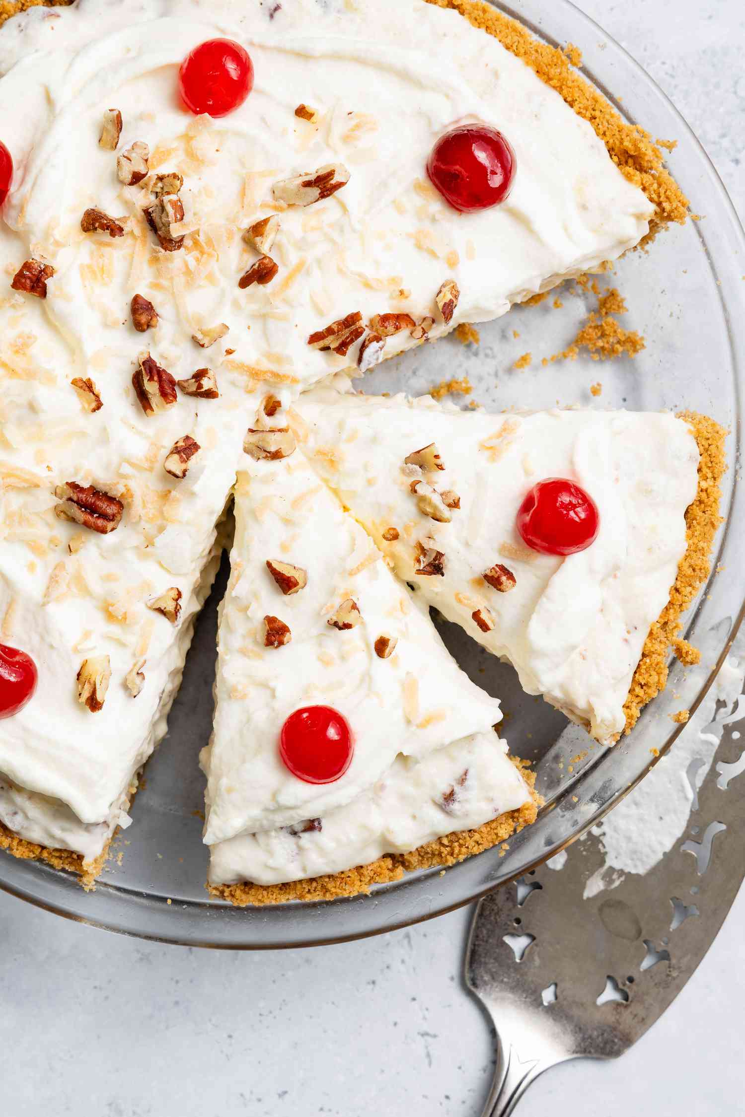 Million Dollar Pie With Some of It Cut Into Slices in a Pie Dish, and on the Counter Next to It, a Pie Server 