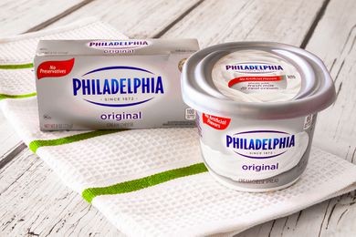 Philadelphia cream cheese (box and container, side by side) on the counter