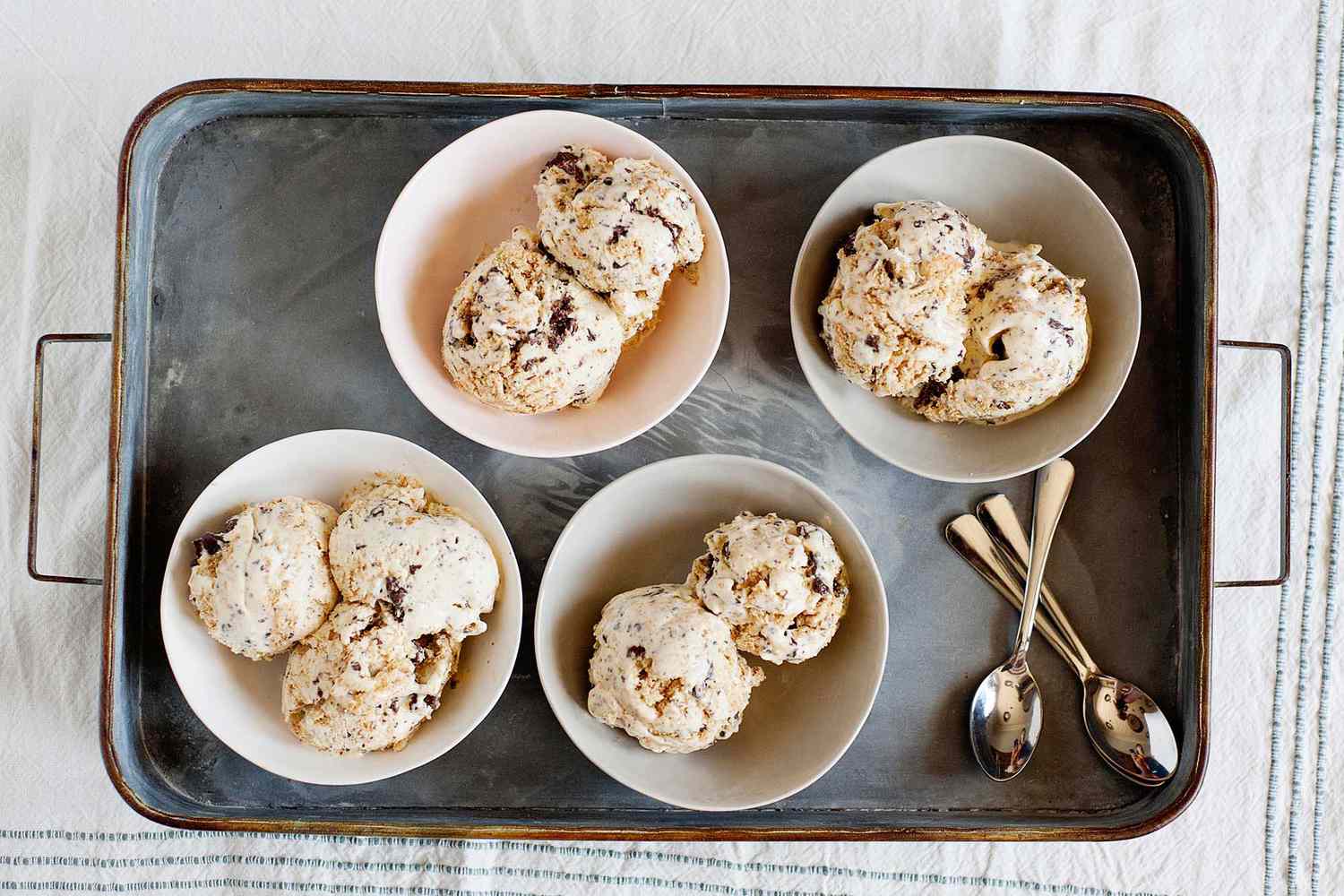 Homemade S’mores Ice Cream Recipe - scoops of ice cream in small bowls on a silver tray