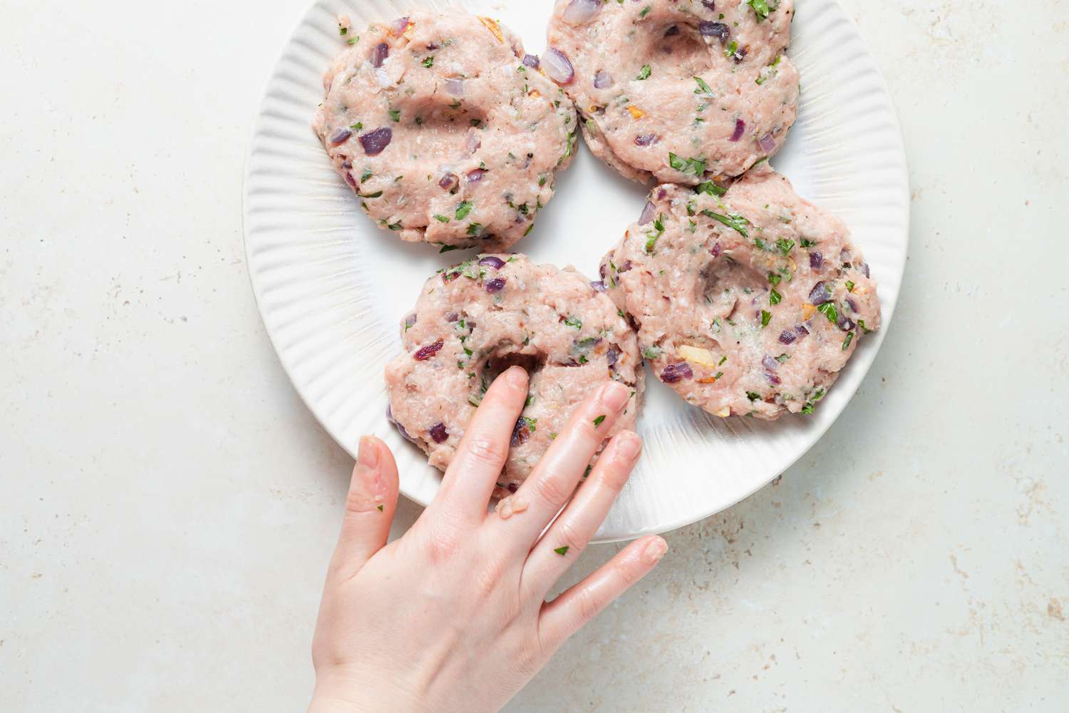 Turker burger patties on a plate to show how to make turkey burgers.