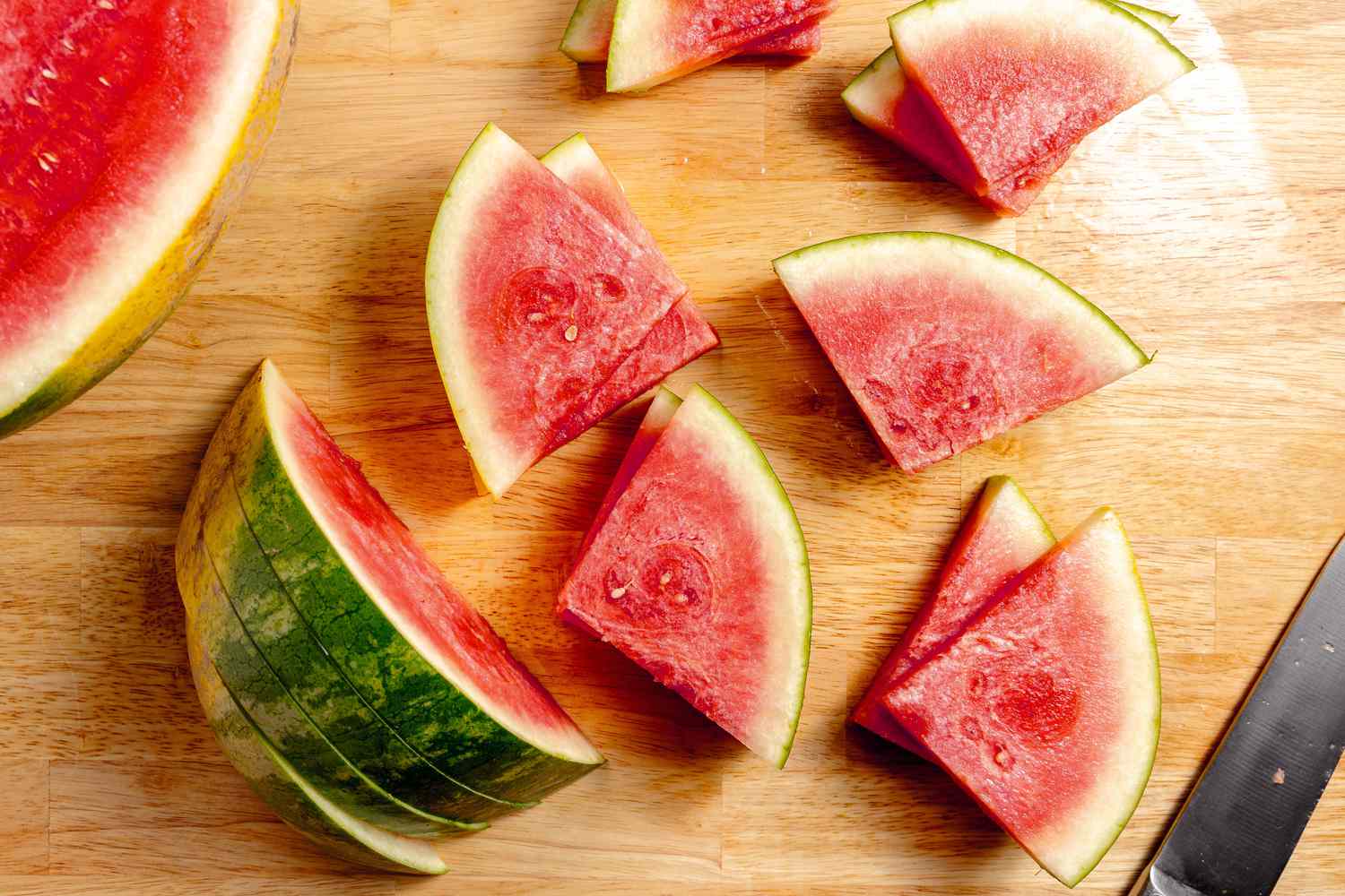 Watermelon in the process of being cut into triangles