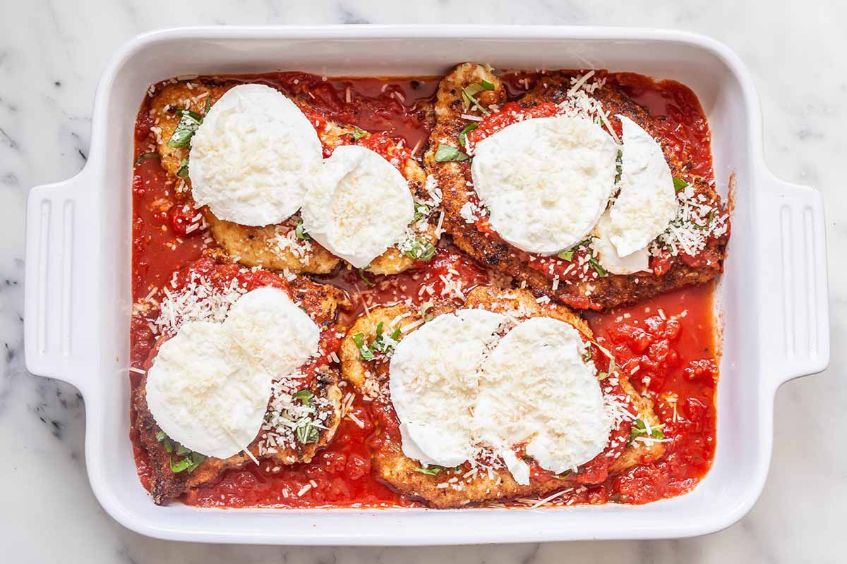Prep the chicken parmesan for the oven in the casserole dish