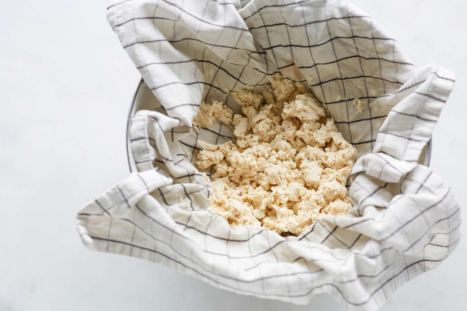 Drained tofu for Korean pork and chives dumplings.