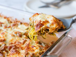 Zucchini Noodle Casserole in a Casserole Dish with Some on a Spatula