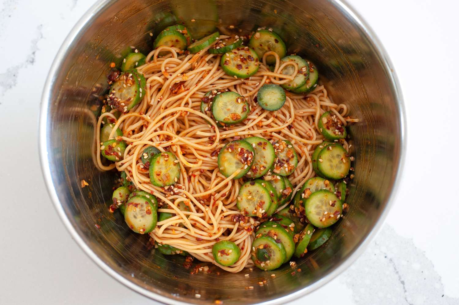 Noodles tossed with cucumbers and chili crisp.