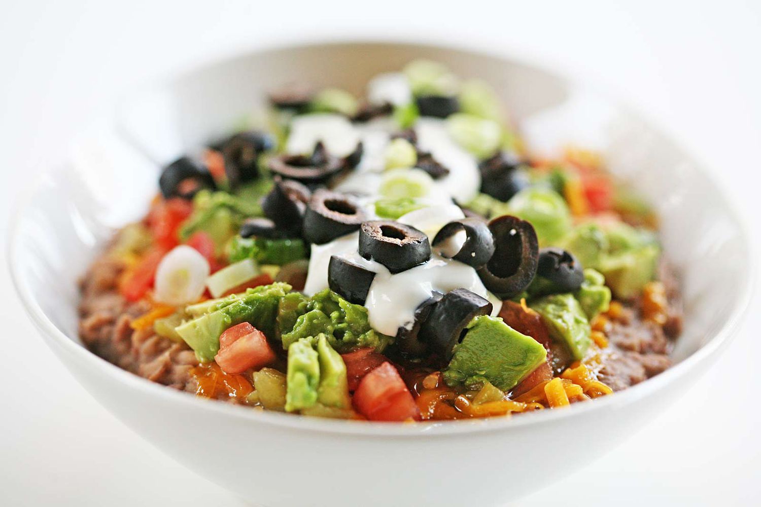 seven layer bean dip in a bowl