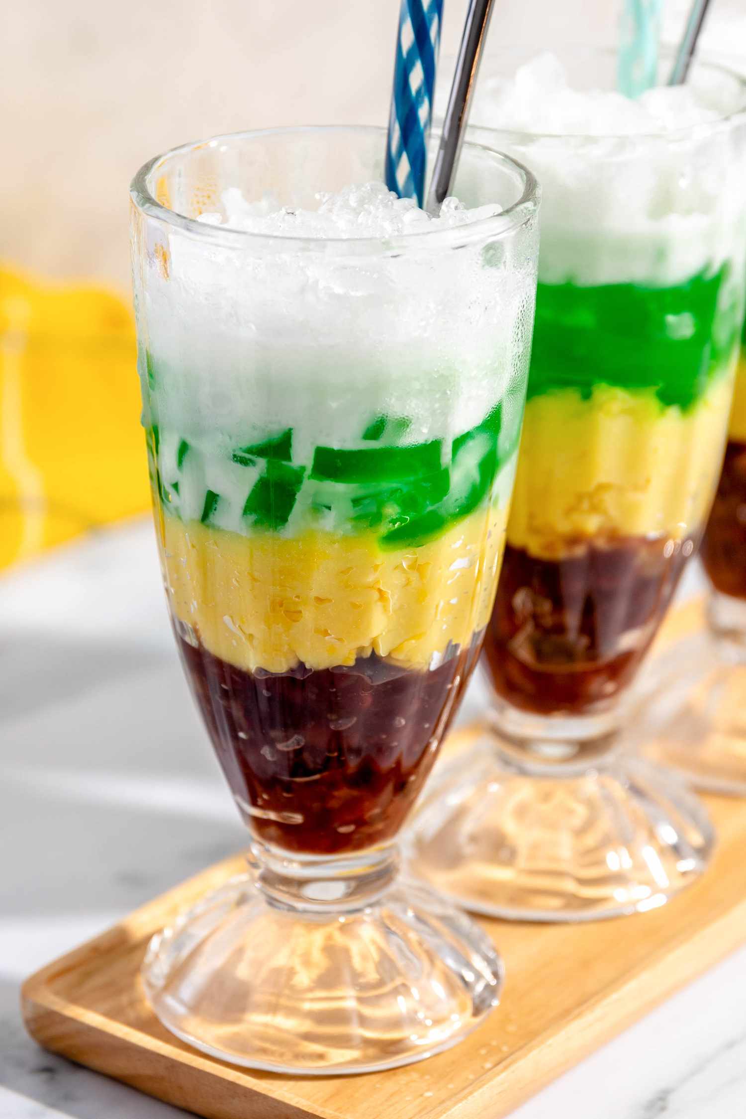 Glasses of ChÃ¨ Ba MÃ u on a Tray With a Straw and a Tall Spoon