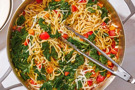 One-Pot Spaghetti with Kale in a pot with tongs
