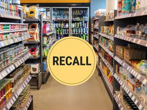 Grocery store aisle with a large 'Recall' sign overlay
