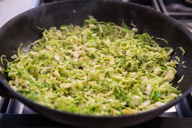 cooked shaved brussels sprouts in a skillet