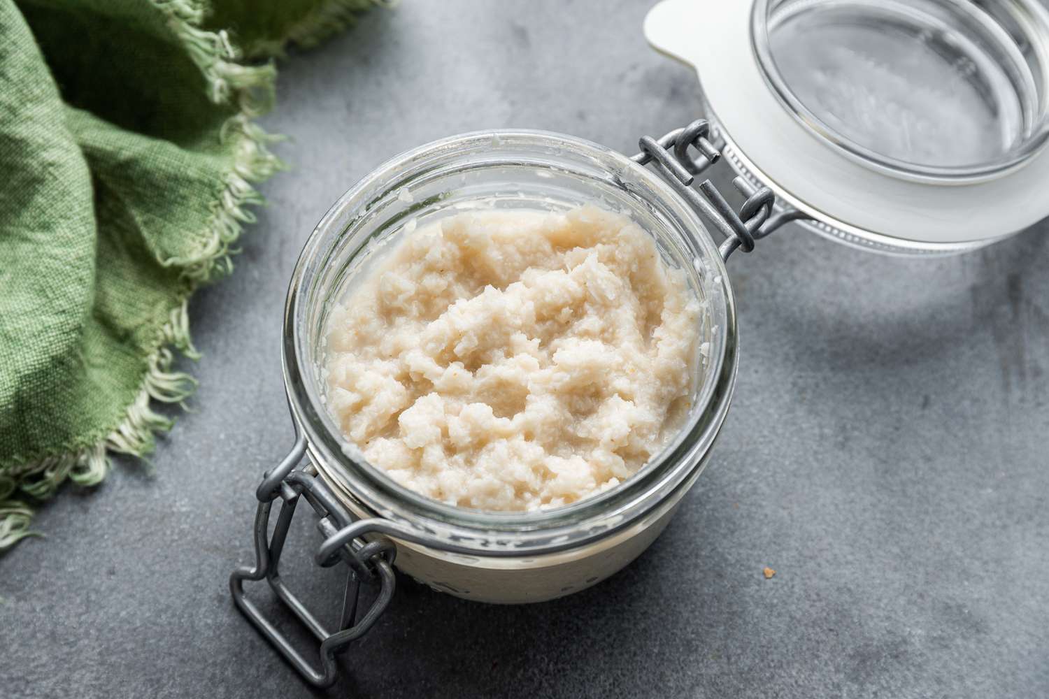An open jar of homemade prepared horseradish