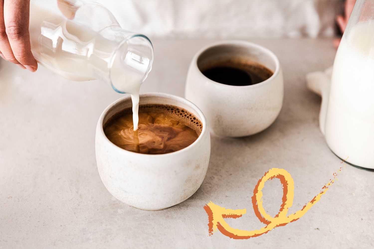 Pouring cream into a cup of coffee