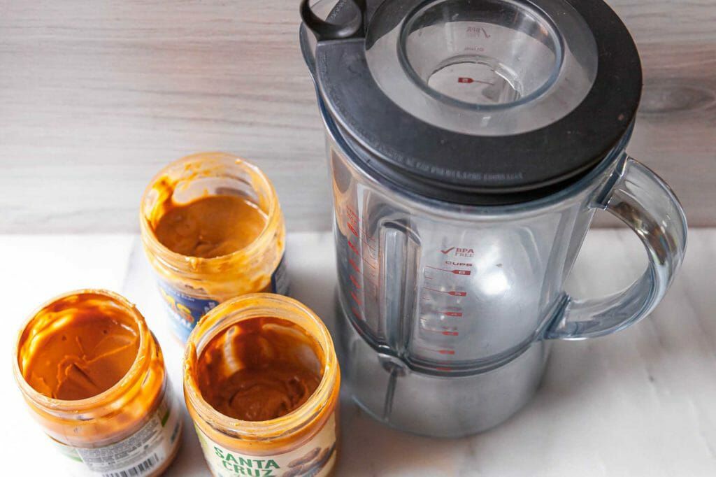 Blending natural peanut butter in a blender