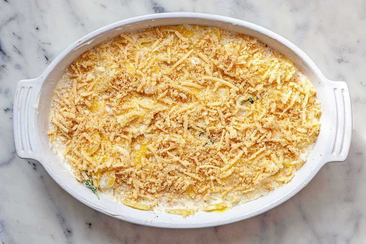 Easy Au Gratin potatoes in an oval baking dish and topped with breadcrumbs.