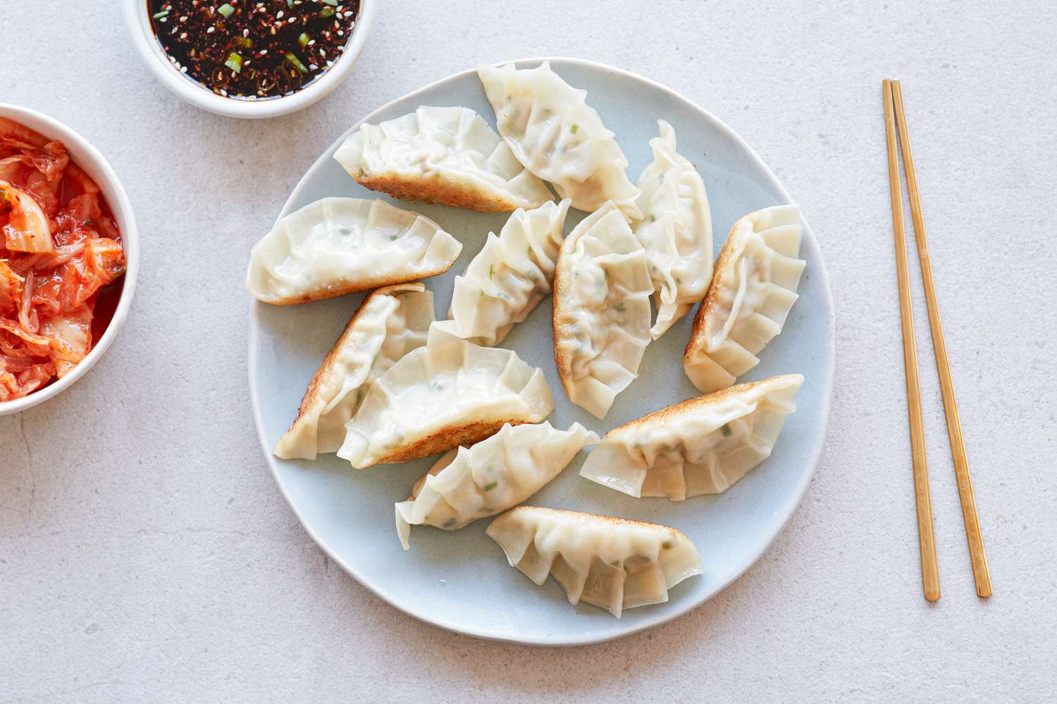 Overhead view of Korean pork and chives dumplings on a plate.