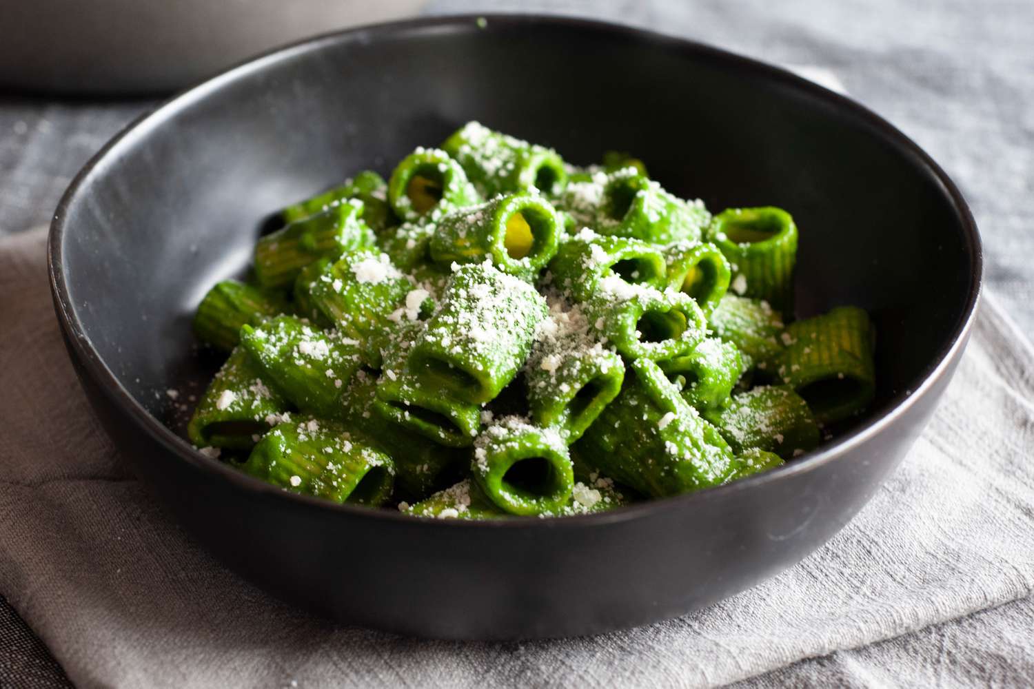 Swiss chard, lemon, and parmesan pasta heaped in a low bowl.