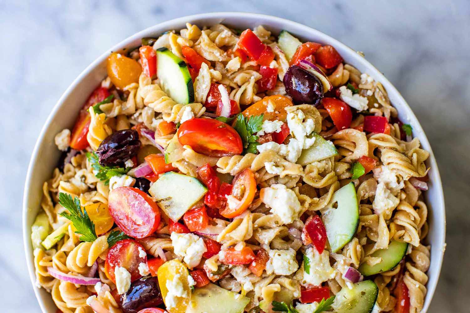 A serving bowl of Greek pasta salad