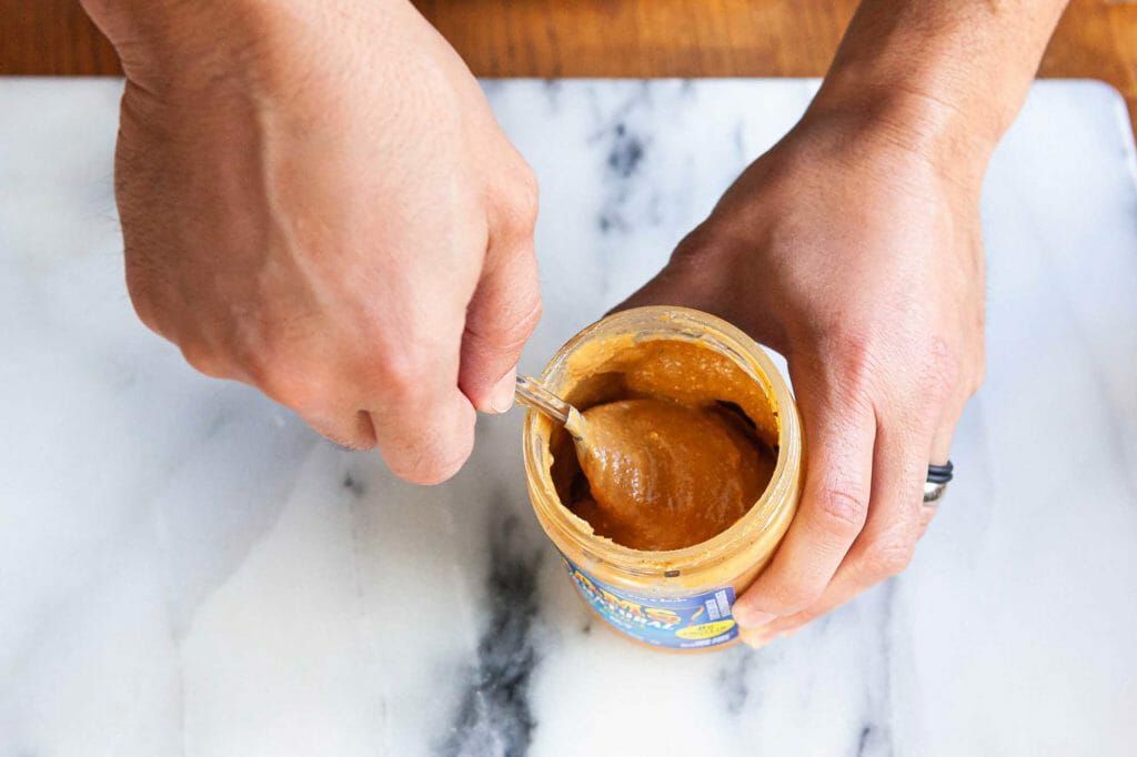 Stir natural peanut butter with a spoon