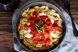 Pasta with ricotta and pan-fried tomato sauce in a bowl